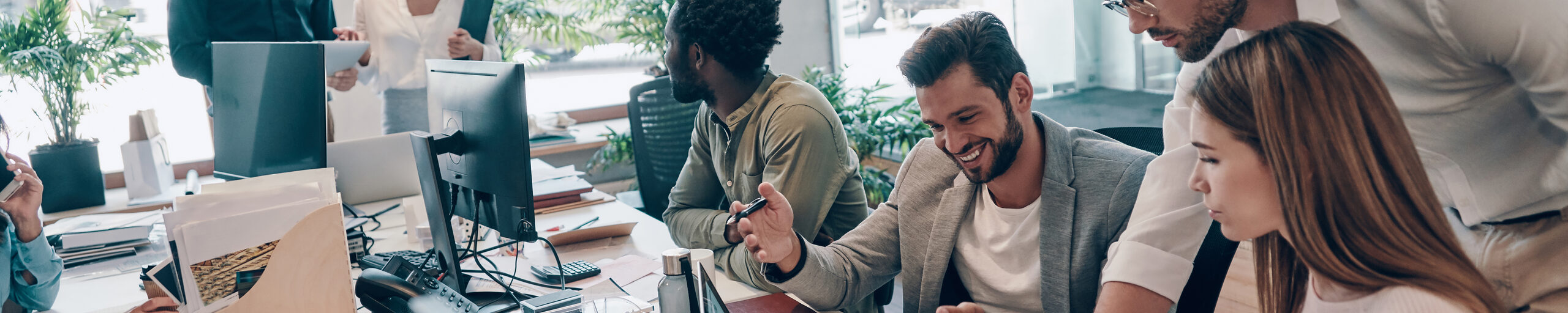 Junge Menschen arbeiten gemeinsam an einem Schreibtisch