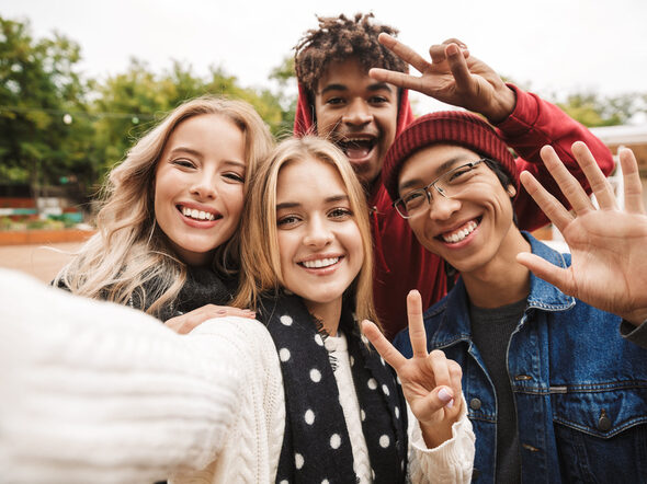 Gruppe fröhlicher junger Leute macht ein Selfie